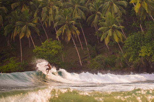 Sri Lanka Travel Photography Mirissa Beach surfer surfing at sunset South Coast of Sri Lanka Southern Province Asia