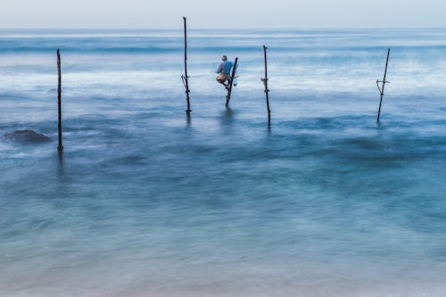Sri Lanka Travel Photography Stilt fisherman fishing at Midigama near Weligama South Coast Sri Lanka Asia