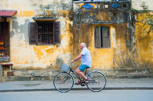 Vietnam Travel Photography Tourist Cycling Around the Streets of Hoi An Vietnam Southeast Asia