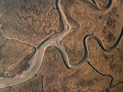Drone Photography by UK London Freelance Drone Photographer Aerial drone photo of the meandering winding River Glaven estuary at Blakeney Point England UK showing patterns in nature
