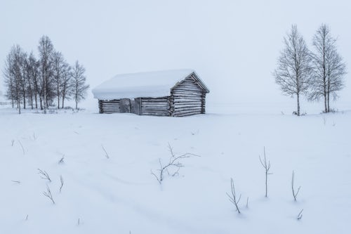 Landscape Photography by Professional Freelance UK Landscape Photographer Cabin in a cold winter landscape in Lapland inside the Arctic Circle in Finland